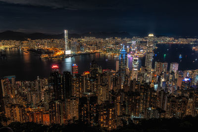 Illuminated cityscape against sky at night