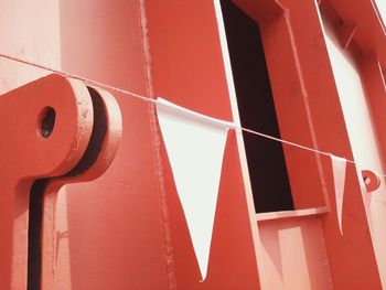 Bunting flags against red metallic gate