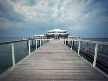 Pier over sea against sky