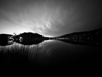 Scenic view of lake against sky at night