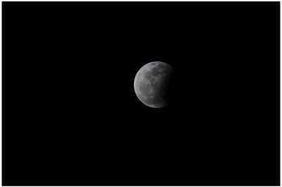 Low angle view of moon against clear sky at night