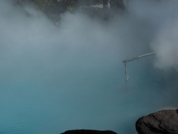 Low angle view of foggy weather against sky
