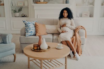 Woman sitting on sofa at home