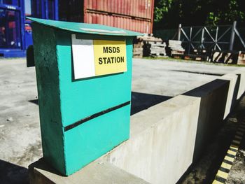 Close-up of sign on railing