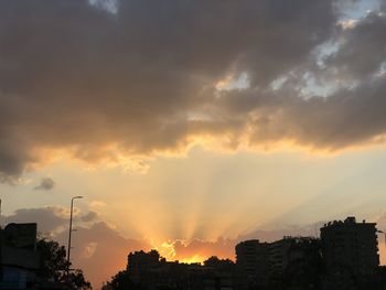 Silhouette buildings against sky during sunset