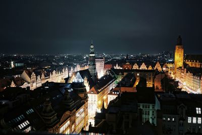 High angle view of illuminated buildings in city at night