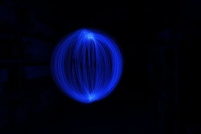 Illuminated light painting against black background