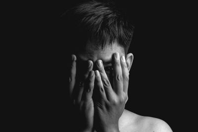 Close-up of human hand against black background