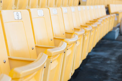 Empty yellow seats at stadium,rows of seat on a soccer stadium,select focus