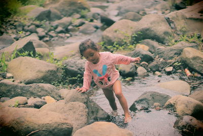 Full length of girl on rock