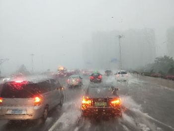 Cars on wet street during rainy season