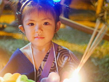 A baby girl, 3 years old, during the loy krathong festival in thailand 