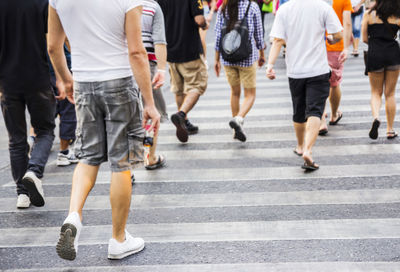 Low section of people walking on road