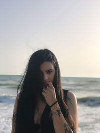 Young woman sitting at beach