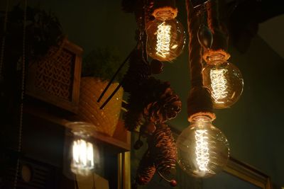 Low angle view of illuminated light bulbs at home