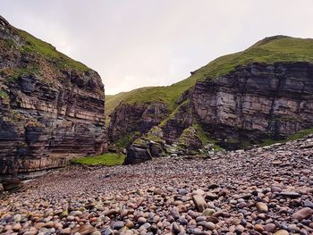 Rock formation on land against sky