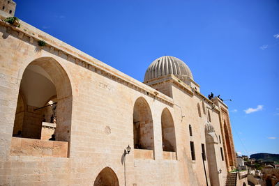 Low angle view of historic building against clear blue sky