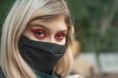 Close-up portrait of woman wearing mask