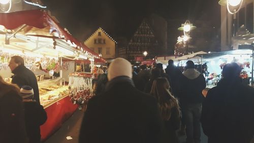 Rear view of people photographing illuminated