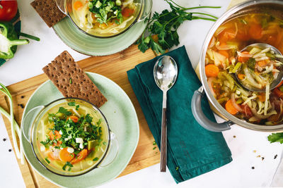 Two plates with vegan food, cabbage soup on the table at home