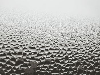 Full frame shot of wet glass window during monsoon