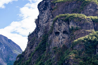 Low angle view of rock formation against sky