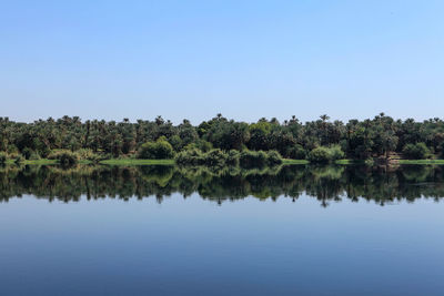 Scenic view of lake against clear blue sky