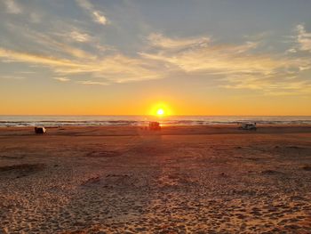 Scenic view of beach against sky during sunset