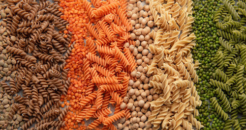 A variety of fusilli pasta made from different types of legumes, green and red lentils, 