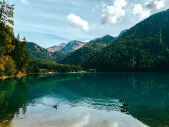 Scenic view of lake by mountains against sky