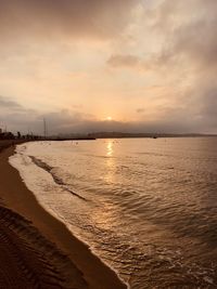 Scenic view of beach against sky during sunset