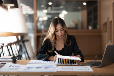 Young woman using laptop on table