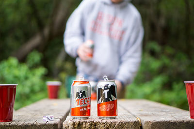 Close-up of person standing by bottles