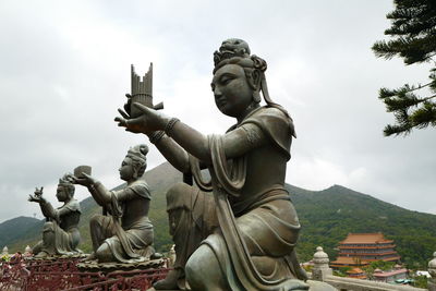 Low angle view of statue against sky