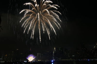 Low angle view of firework display at night