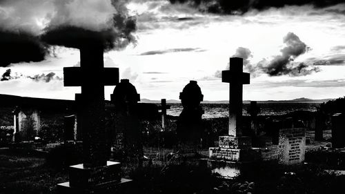 Silhouette of building against cloudy sky