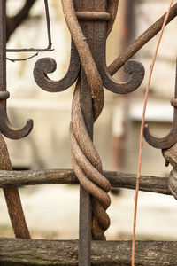 Close-up of chain tied to metal fence