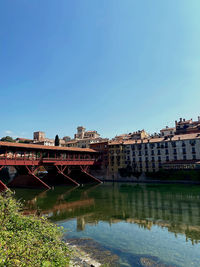 Bridge over river against clear blue sky