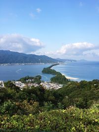 Scenic view of sea and mountains against sky