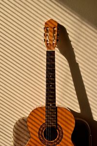 Guitar against beige wall