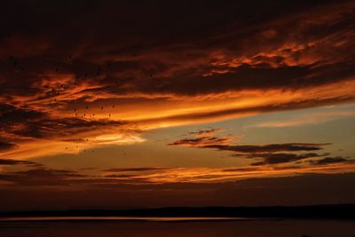 Idyllic shot of lake against orange cloudy sky during sunset