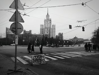 People walking on road against building