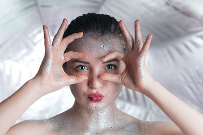 Portrait of young woman with glitters