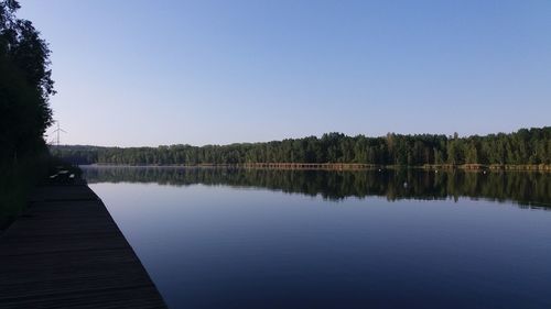 Scenic view of lake against clear blue sky