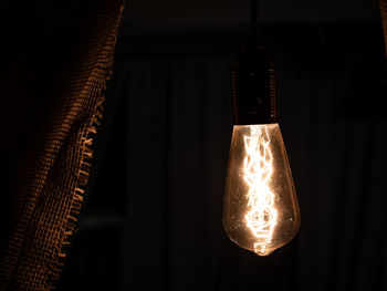 Low angle view of illuminated light bulb