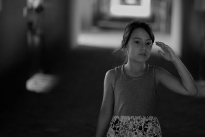 Front view of girl walking on aisle in stable