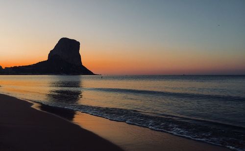 Scenic view of sea against clear sky during sunset