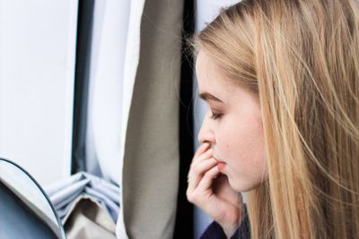 Close-up of woman sleeping in car