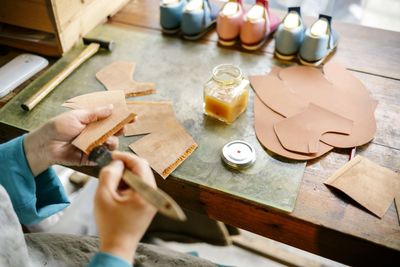 High angle view of woman hand on table