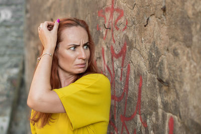 Woman looking at graffiti wall